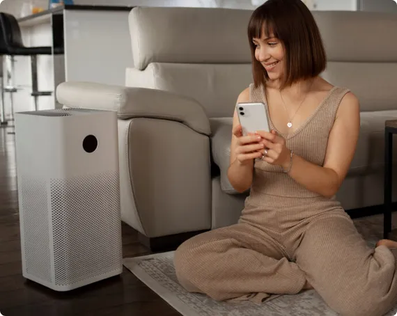 Woman relaxing at home with her phone