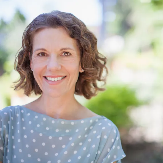 Smiling woman with short curly hair